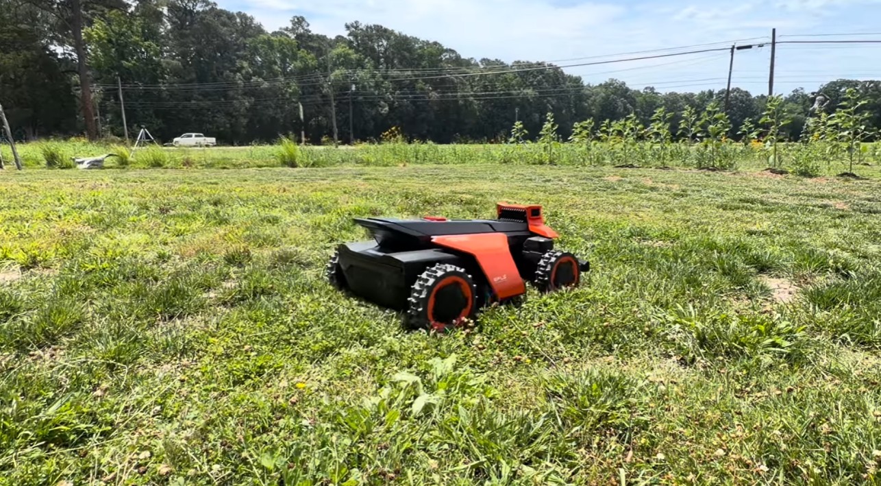 A Navimow Terranox commercial robot mower cutting a large open meadow