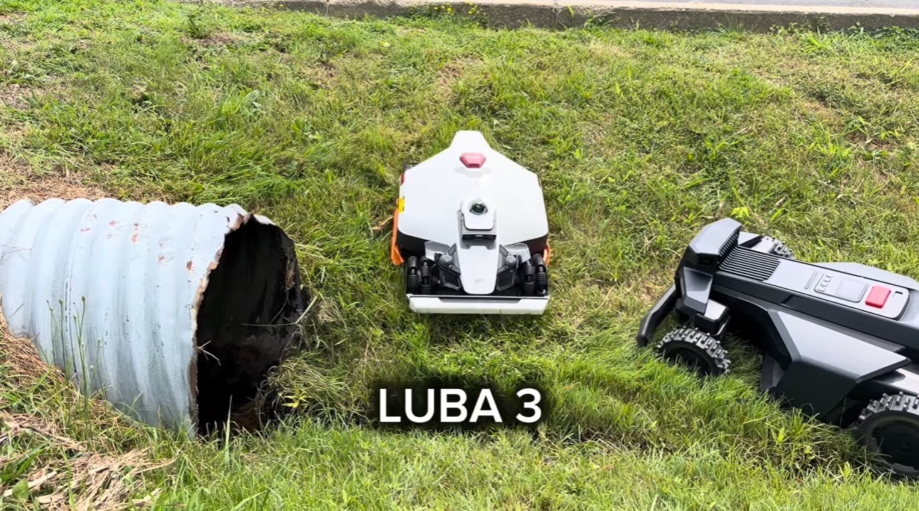 The Mammotion LUBA 3 and Segway Navimow X4 crossing a rutted, ditched grassy slope during the field test