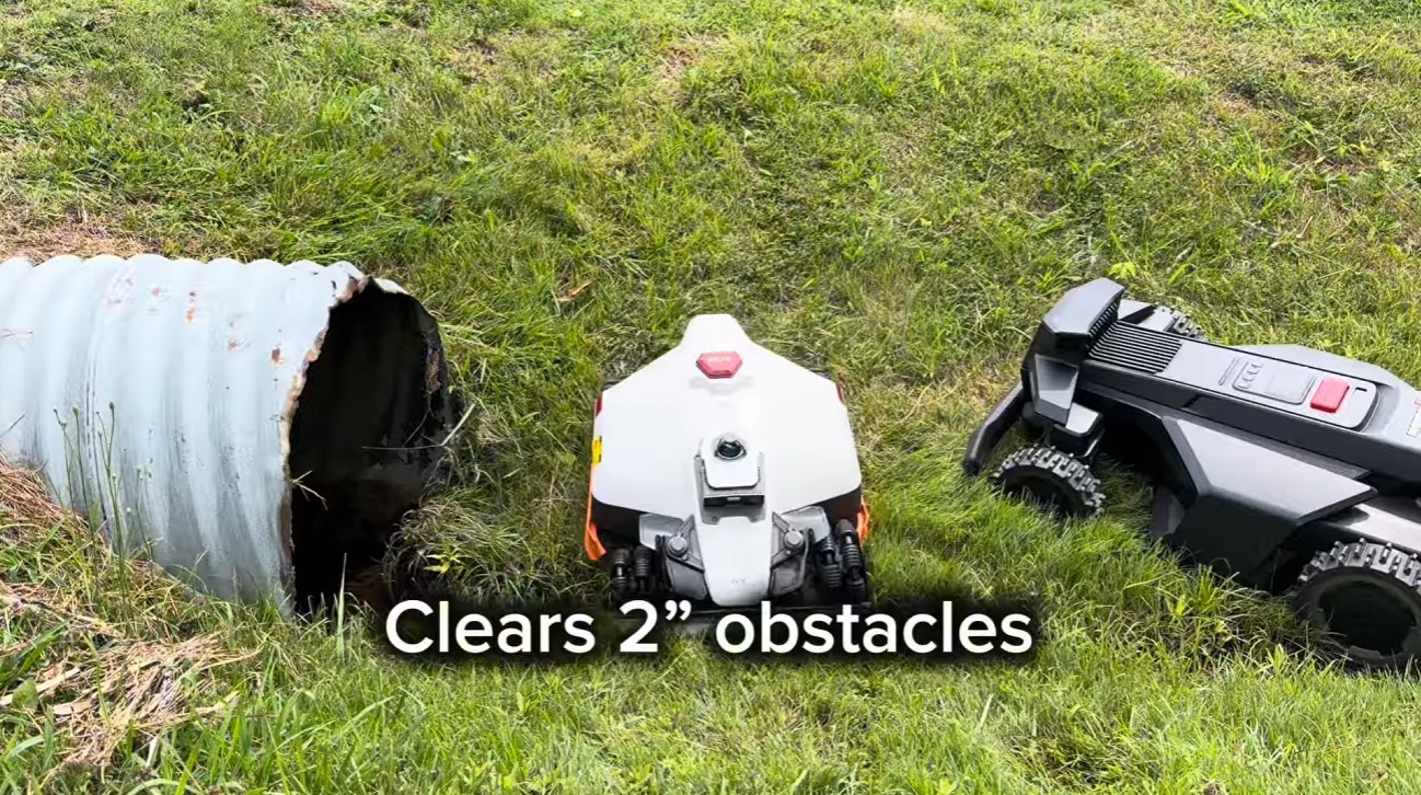 A robot mower clearing a 2-inch obstacle in tall grass during a field test