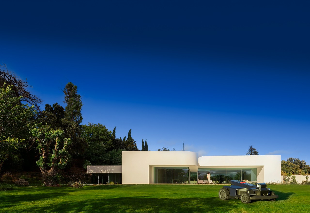 A modernist white home on a pristine designed lawn with a robotic mower — the landscape shaped by intent, not deck access