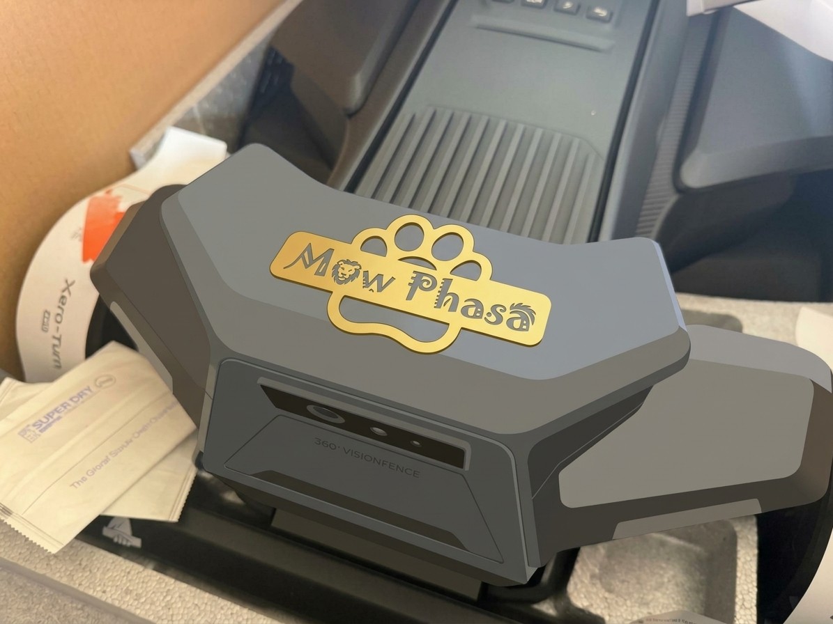 A gold “Mow Phasa” nameplate with a lion and a paw print on the front of a Navimow X4