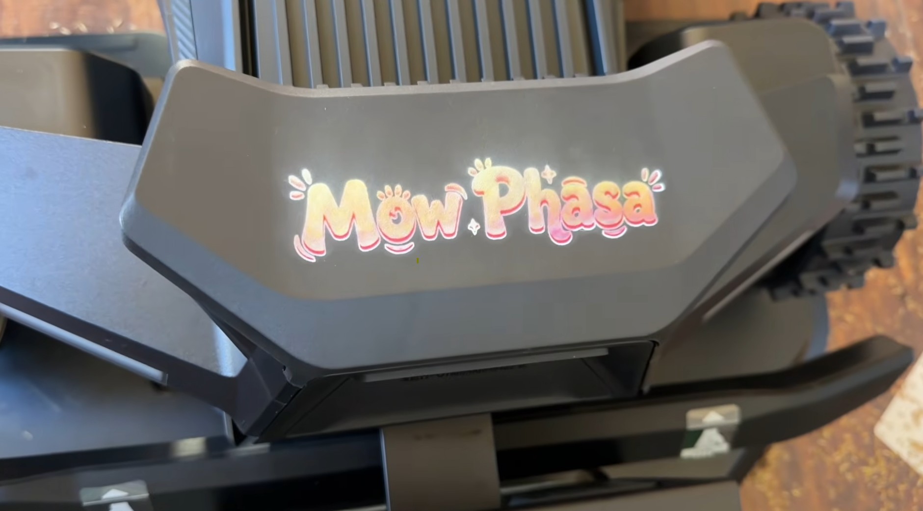 The “Mow Phasa” custom nameplate mounted on the front of a Segway Navimow X4 robot mower